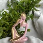 1000030214.jpg - Bling On Decor® | Luxury Handmade Home Decor Abstract pink metallic sculpture of a couple embracing, set on a round base with green plants in the background. - Bling On Decor® | Luxury Handmade Home Decor ANJU BALA