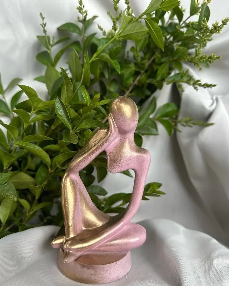 1000030214.jpg - Bling On Decor® | Luxury Handmade Home Decor Abstract pink metallic sculpture of a couple embracing, set on a round base with green plants in the background. - Bling On Decor® | Luxury Handmade Home Decor ANJU BALA