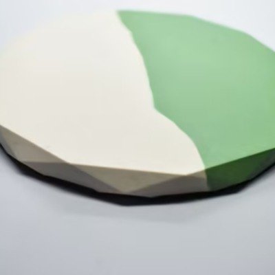Low-poly green and white gemstone–like object resting on a light surface, showing faceted sides. - Bling On Decor® | Luxury Handmade Home Decor ANJU BALA