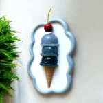BLING-ON-Blue-Ice-Cream-Cone-3D-Wall-Art-Sculpture-Luxe-Pop-Art-Decor-Bling-On-2.webp - Bling On Decor® | Luxury Handmade Home Decor Decorative art piece: a stacked blue-gray ice cream cone with a cherry on top inside a molded frame. - Bling On Decor® | Luxury Handmade Home Decor ANJU BALA