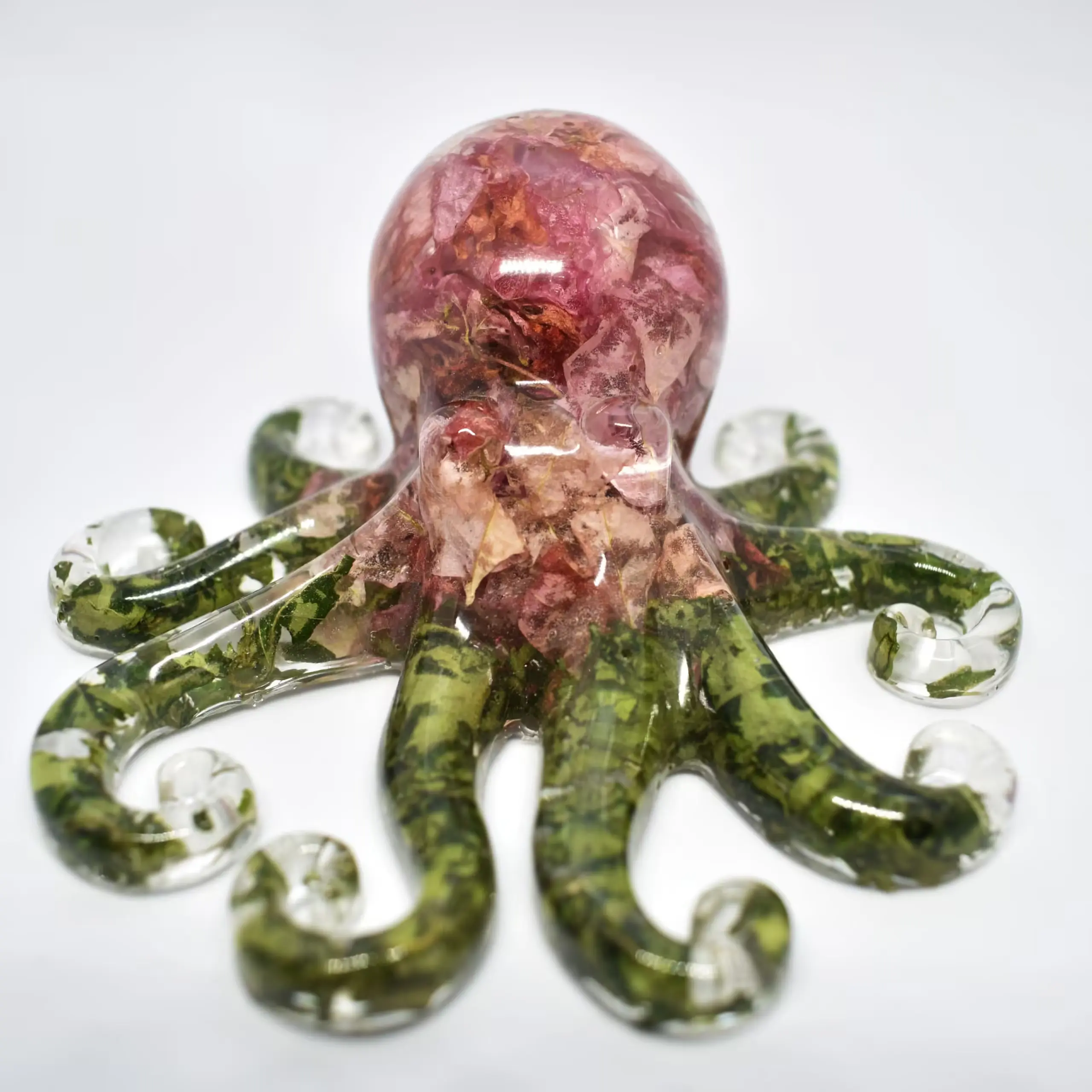 Translucent pink bust sculpture encircled by green marbled glass pieces on a white background. - Bling On Decor® | Luxury Handmade Home Decor ANJU BALA