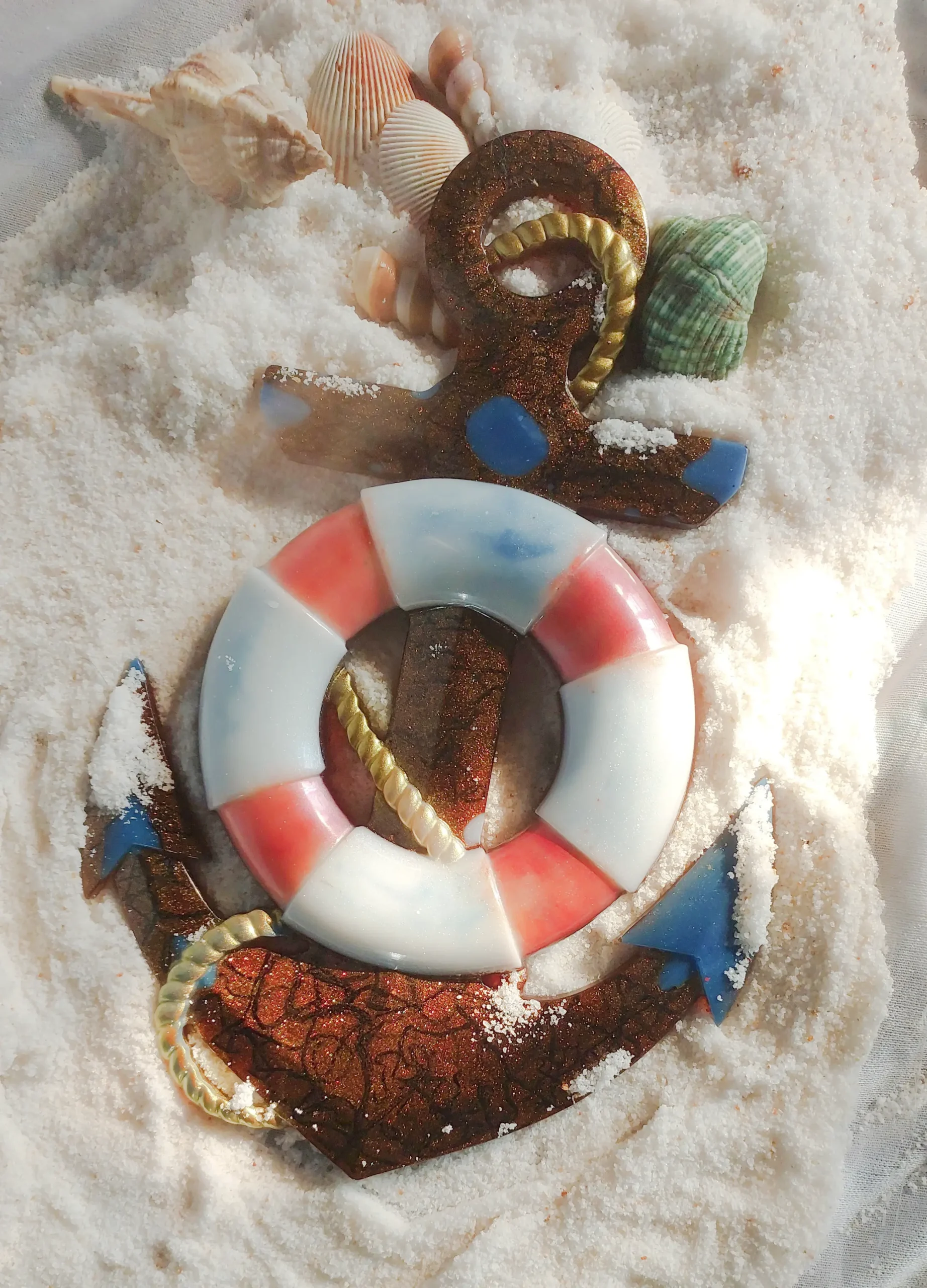 Nautical-themed Christmas ornament resting on white sand with seashells scattered around it. - Bling On Decor® | Luxury Handmade Home Decor ANJU BALA