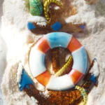 Decorative beach-themed craft on white sand featuring seashells, a glittery brown number '2' with yellow rope, and a blue-orange lifebuoy centerpiece. - Bling On Decor® | Luxury Handmade Home Decor ANJU BALA