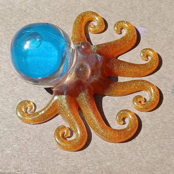 Glittery orange octopus toy with a blue dome head on a flat surface. - Bling On Decor® | Luxury Handmade Home Decor ANJU BALA