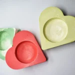 Bling-On-Tealight-Candle-Holder-I-set-of-3-Valentines-Day-Gift-Minimalistic-Home-decor-Handmade-Gifts-7.webp - Bling On Decor® | Luxury Handmade Home Decor Assorted pastel wooden hearts in green, red, and yellow on a light surface. - Bling On Decor® | Luxury Handmade Home Decor ANJU BALA