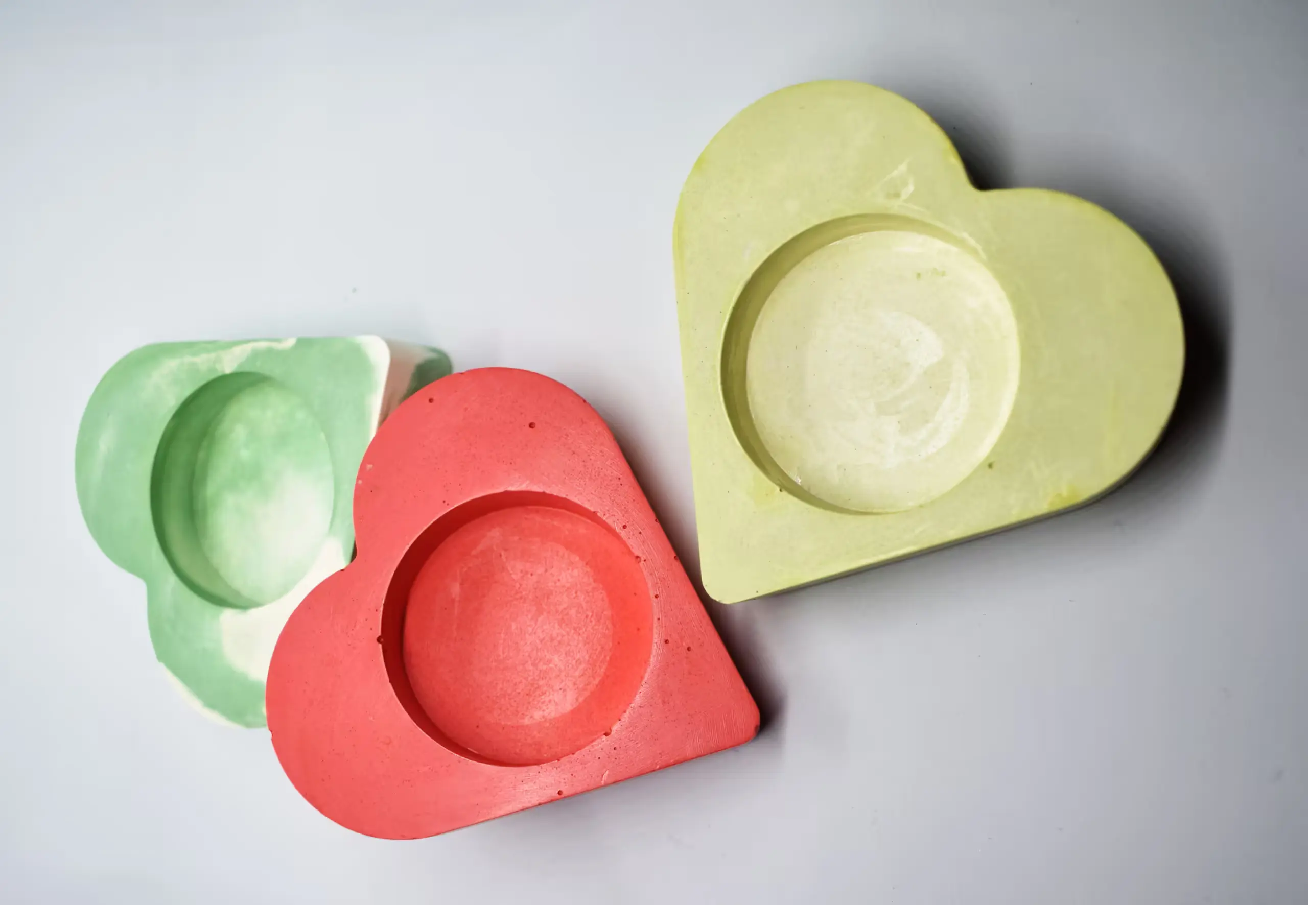 Bling-On-Tealight-Candle-Holder-I-set-of-3-Valentines-Day-Gift-Minimalistic-Home-decor-Handmade-Gifts-7.webp - Bling On Decor® | Luxury Handmade Home Decor Assorted pastel wooden hearts in green, red, and yellow on a light surface. - Bling On Decor® | Luxury Handmade Home Decor ANJU BALA