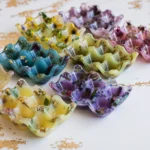 Assorted colorful fluted ceramic bowls with floral patterns arranged on a white surface. - Bling On Decor® | Luxury Handmade Home Decor ANJU BALA