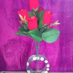 Bouquet of red roses with green leaves in a round glass vase filled with shells on a purple patterned background. - Bling On Decor® | Luxury Handmade Home Decor ANJU BALA