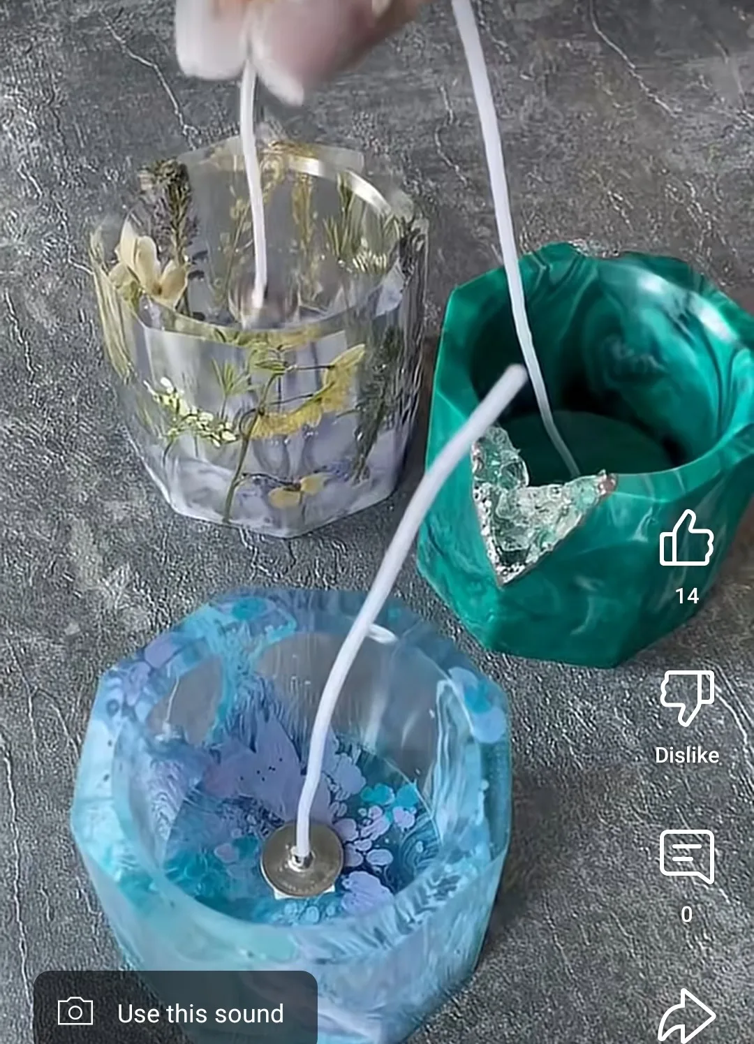 Close-up of a glass vase with dried flowers submerged in liquid, connected by a white tube to a green bag and a blue ice bucket on a textured surface. - Bling On Decor® | Luxury Handmade Home Decor ANJU BALA