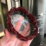 Close-up of a person wearing a sparkly red hair wrap and pink clothing, with a hand in the foreground; on-screen Like/Dislike icons are visible in the video UI. - Bling On Decor® | Luxury Handmade Home Decor ANJU BALA