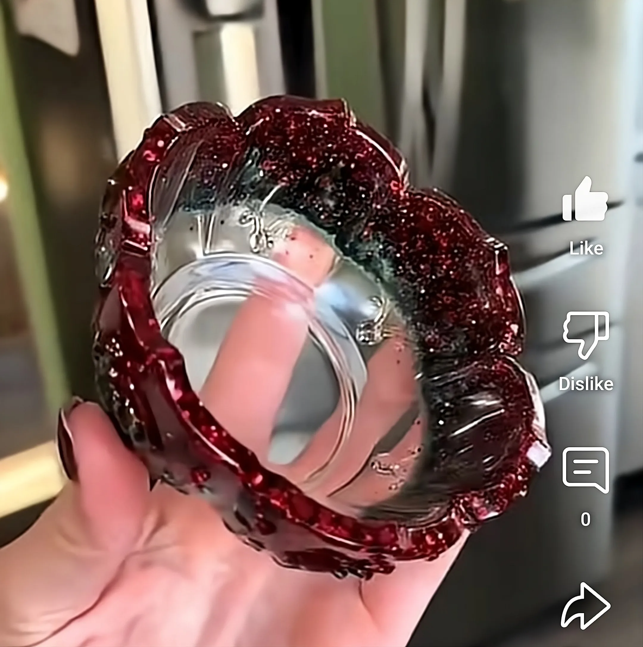 Close-up of a person wearing a sparkly red hair wrap and pink clothing, with a hand in the foreground; on-screen Like/Dislike icons are visible in the video UI. - Bling On Decor® | Luxury Handmade Home Decor ANJU BALA