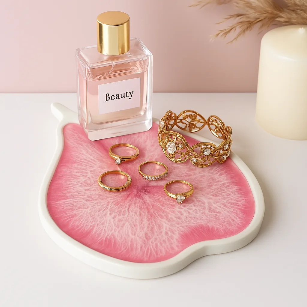 Gold rings and a jeweled bracelet arranged on a pink tray beside a perfume bottle labeled Beauty. - Bling On Decor® | Luxury Handmade Home Decor ANJU BALA