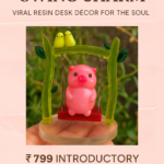 Pink piggy swing charm on a bright green frame, displayed on a pink ad packaging with price ₹799 and a 'Shop Now' button. - Bling On Decor® | Luxury Handmade Home Decor ANJU BALA