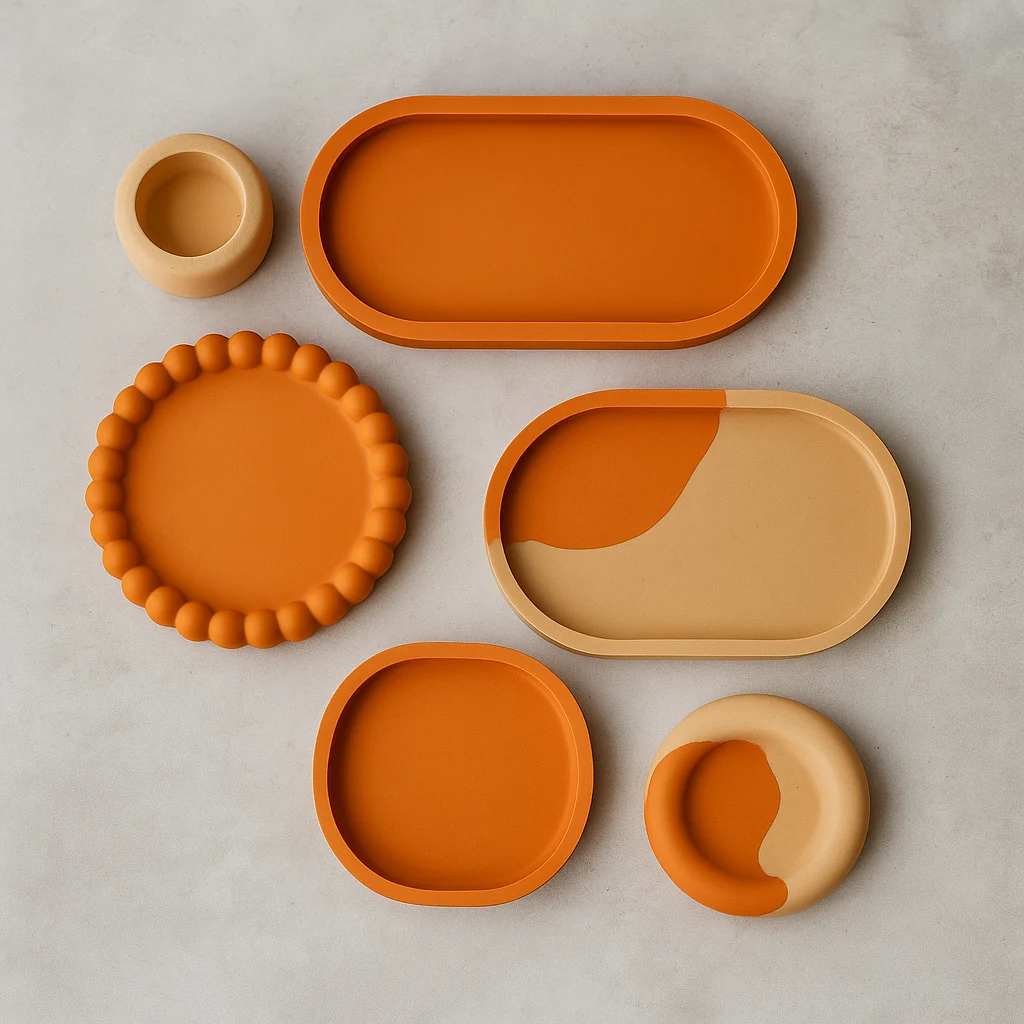 Indias-No1-Handcrafted-Jesmonite-Tray-Coaster-Set-Viral-Home-Decor-for-Gifting-Style-R-1.webp - Bling On Decor® | Luxury Handmade Home Decor Set of orange and beige silicone dinnerware pieces arranged on a light gray surface, including oval tray, round beaded plate, and nested bowls. - Bling On Decor® | Luxury Handmade Home Decor ANJU BALA
