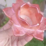 Pink ceramic flower-shaped decorative bowl with a hollow center, held in a hand outdoors. - Bling On Decor® | Luxury Handmade Home Decor ANJU BALA