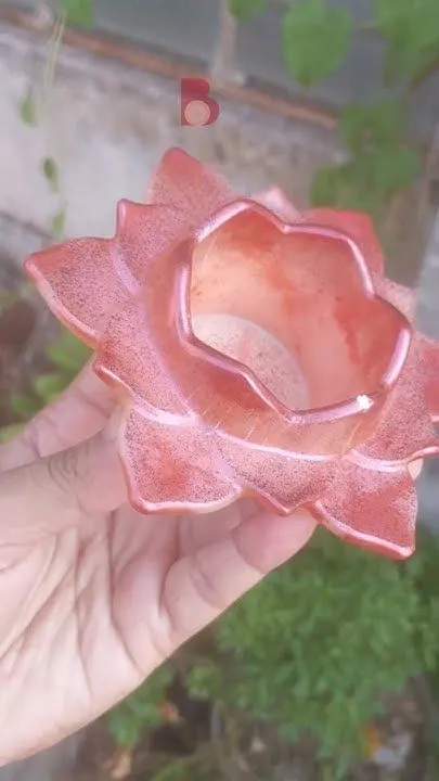 Pink ceramic flower-shaped decorative bowl with a hollow center, held in a hand outdoors. - Bling On Decor® | Luxury Handmade Home Decor ANJU BALA