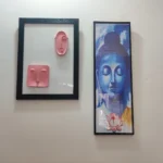 Modern-Abstract-3D-Face-Wall-Art-Frame-Handmade-Resin-Sculpture-Minimalist-Luxury-Home-Decor-by-Bling-On®-India-🇮🇳-3-scaled-1.webp - Bling On Decor® | Luxury Handmade Home Decor Two framed artworks hung side by side: a pink abstract face relief within a white background frame on the left, and a tall blue Buddha portrait within a black frame on the right. - Bling On Decor® | Luxury Handmade Home Decor ANJU BALA