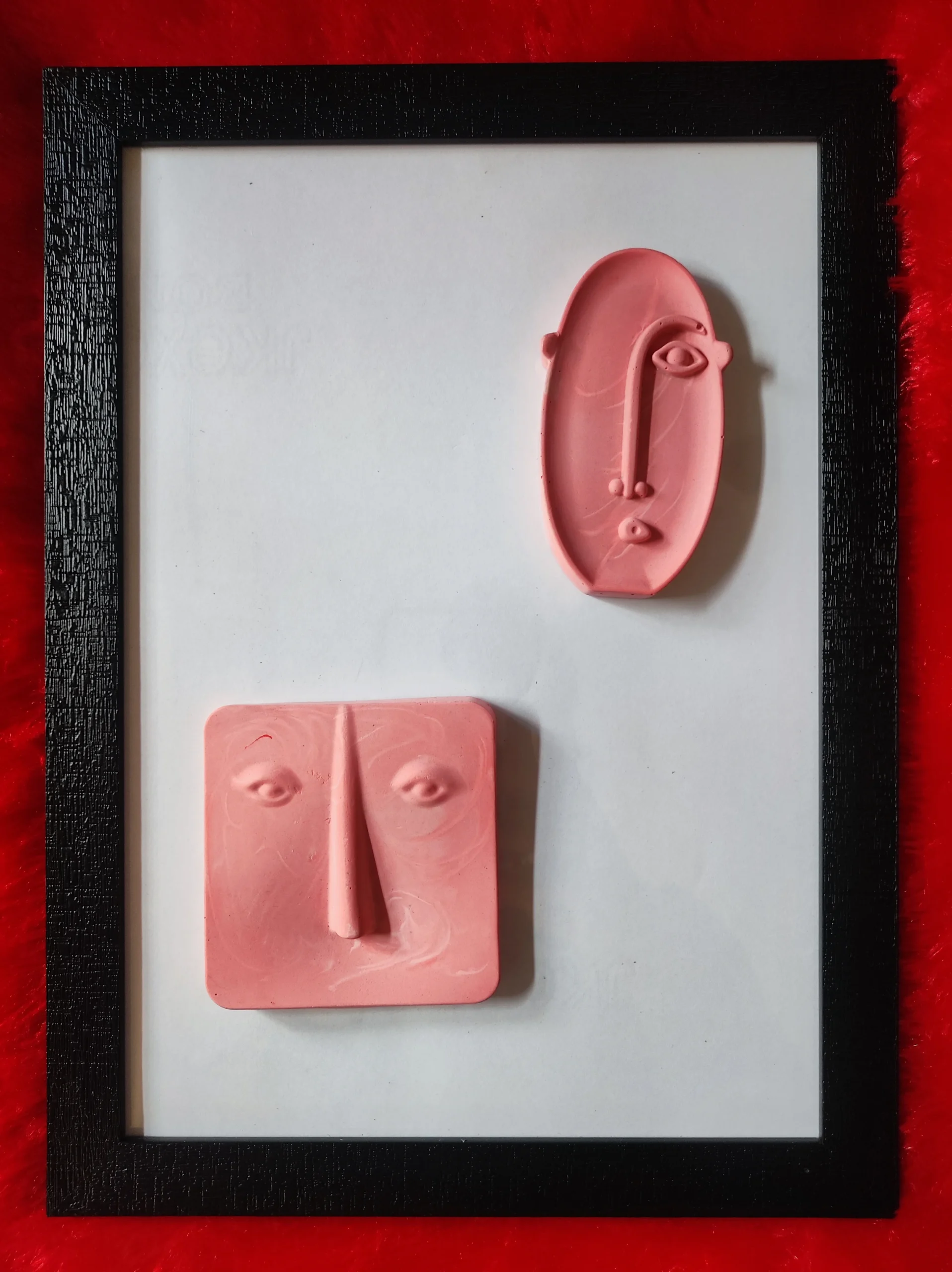 Modern-Abstract-3D-Face-Wall-Art-Frame-Handmade-Resin-Sculpture-Minimalist-Luxury-Home-Decor-by-Bling-On®-India-🇮🇳-4-scaled-1.webp - Bling On Decor® | Luxury Handmade Home Decor Pink clay sculpture of a stylized face with an elongated nose, set inside a black picture frame on a white mat with a red background. - Bling On Decor® | Luxury Handmade Home Decor ANJU BALA