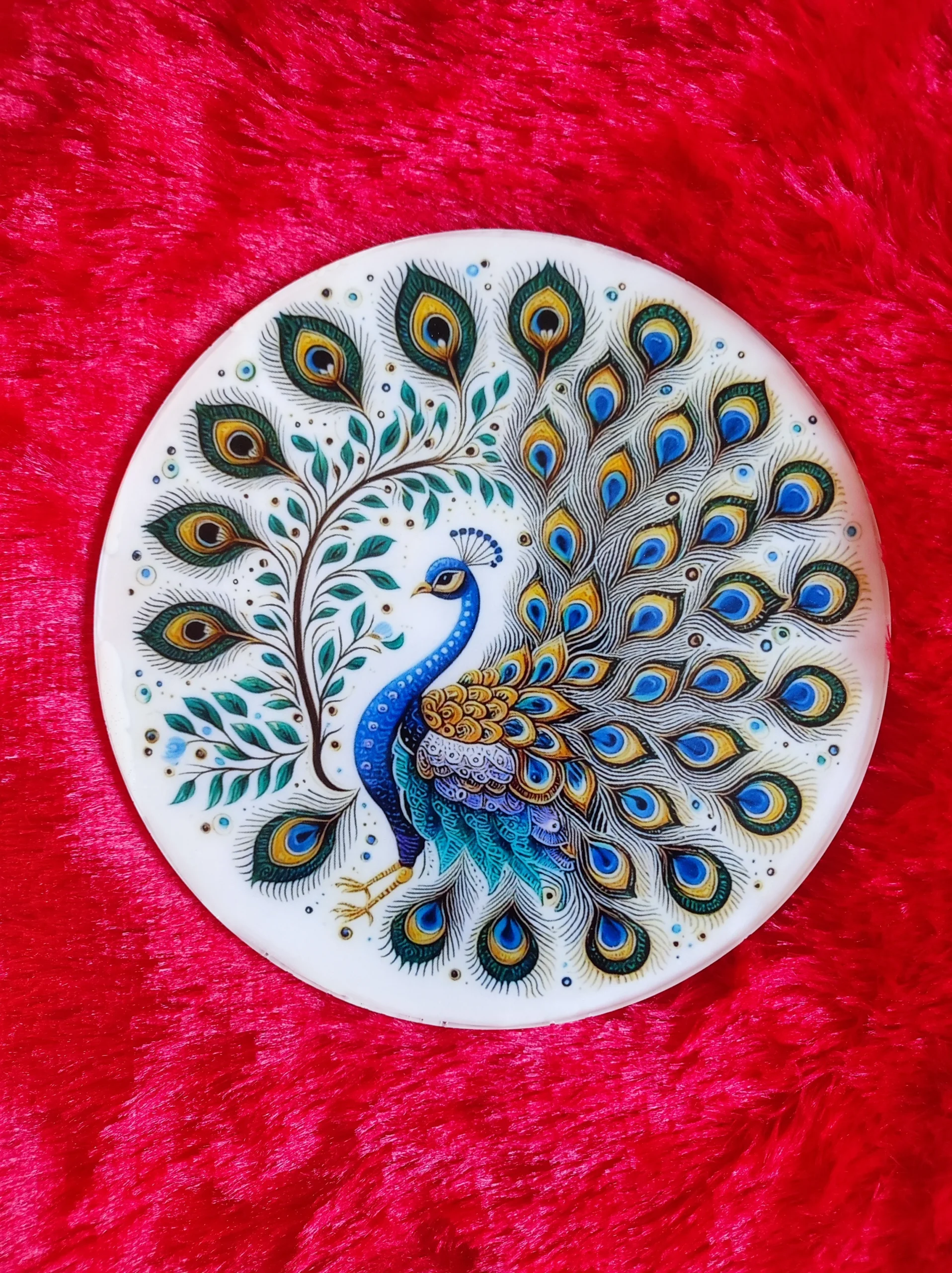 Decorative ceramic plate with a colorful peacock design on a red plush background. - Bling On Decor® | Luxury Handmade Home Decor ANJU BALA