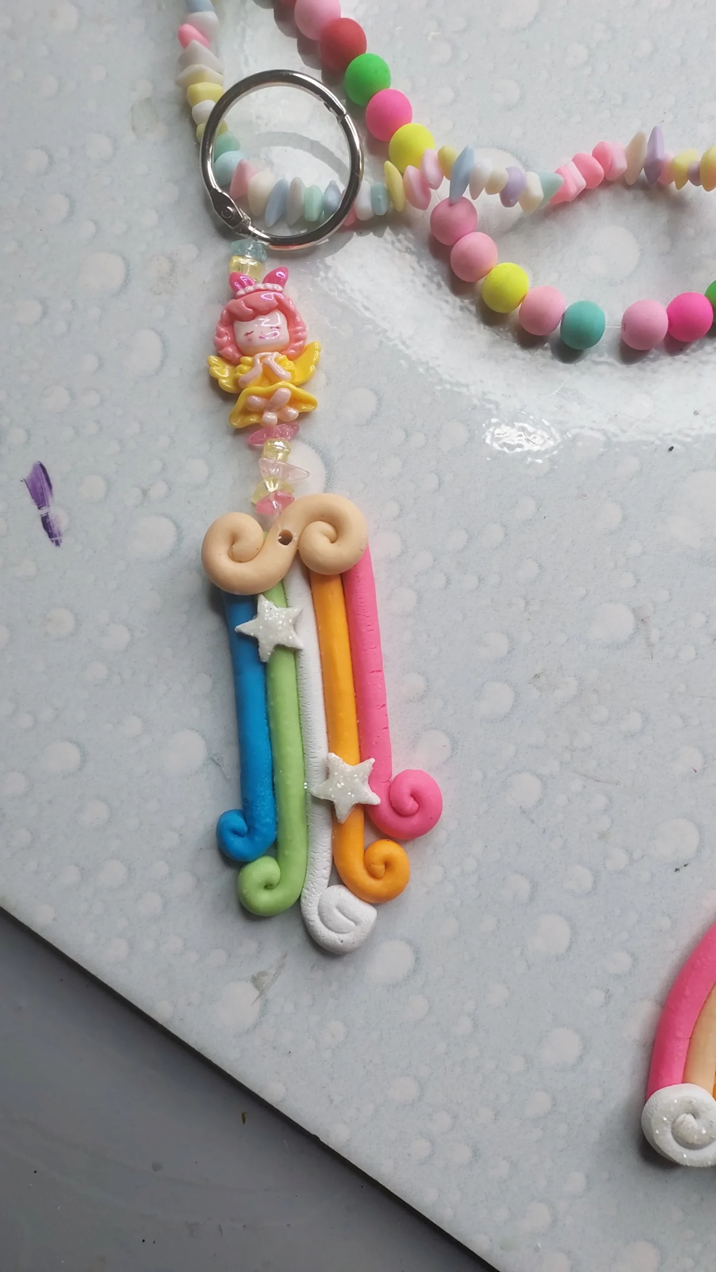 Pastel candy-inspired beaded necklace with a pink girl pendant and star charms on a pale dotted background. - Bling On Decor® | Luxury Handmade Home Decor ANJU BALA