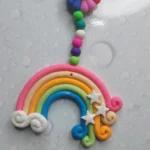Polymer-Clay-Rainbow-Cloud-Window-Hanger-Handmade-Magic-for-Every-Space-✨-6-scaled-1.webp - Bling On Decor® | Luxury Handmade Home Decor Colorful rainbow clay keychain with a smiling sun face and a beaded tassel hanging from a keyring. - Bling On Decor® | Luxury Handmade Home Decor ANJU BALA