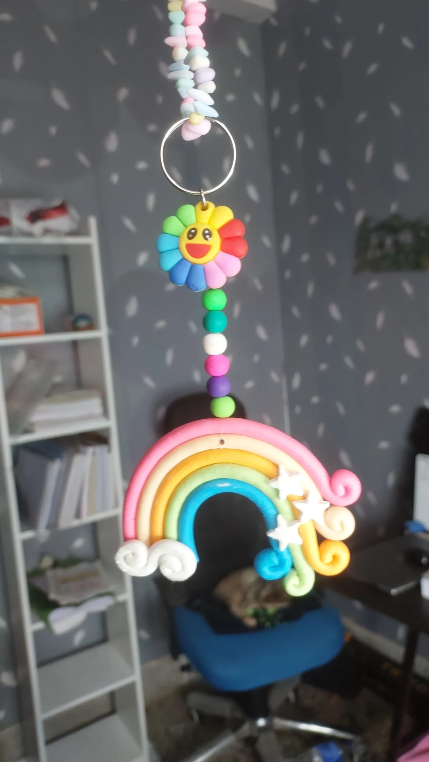 Polymer-Clay-Rainbow-Cloud-Window-Hanger-Handmade-Magic-for-Every-Space-✨-7-scaled-1.webp - Bling On Decor® | Luxury Handmade Home Decor Colorful bead wind chime with a smiling sun flower pendant hanging from a pastel rainbow arch. - Bling On Decor® | Luxury Handmade Home Decor ANJU BALA