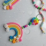 Colorful clay keychain with a rainbow arc, star accents, and a small unicorn bead on a pastel beaded strap with a metal ring rail. - Bling On Decor® | Luxury Handmade Home Decor ANJU BALA