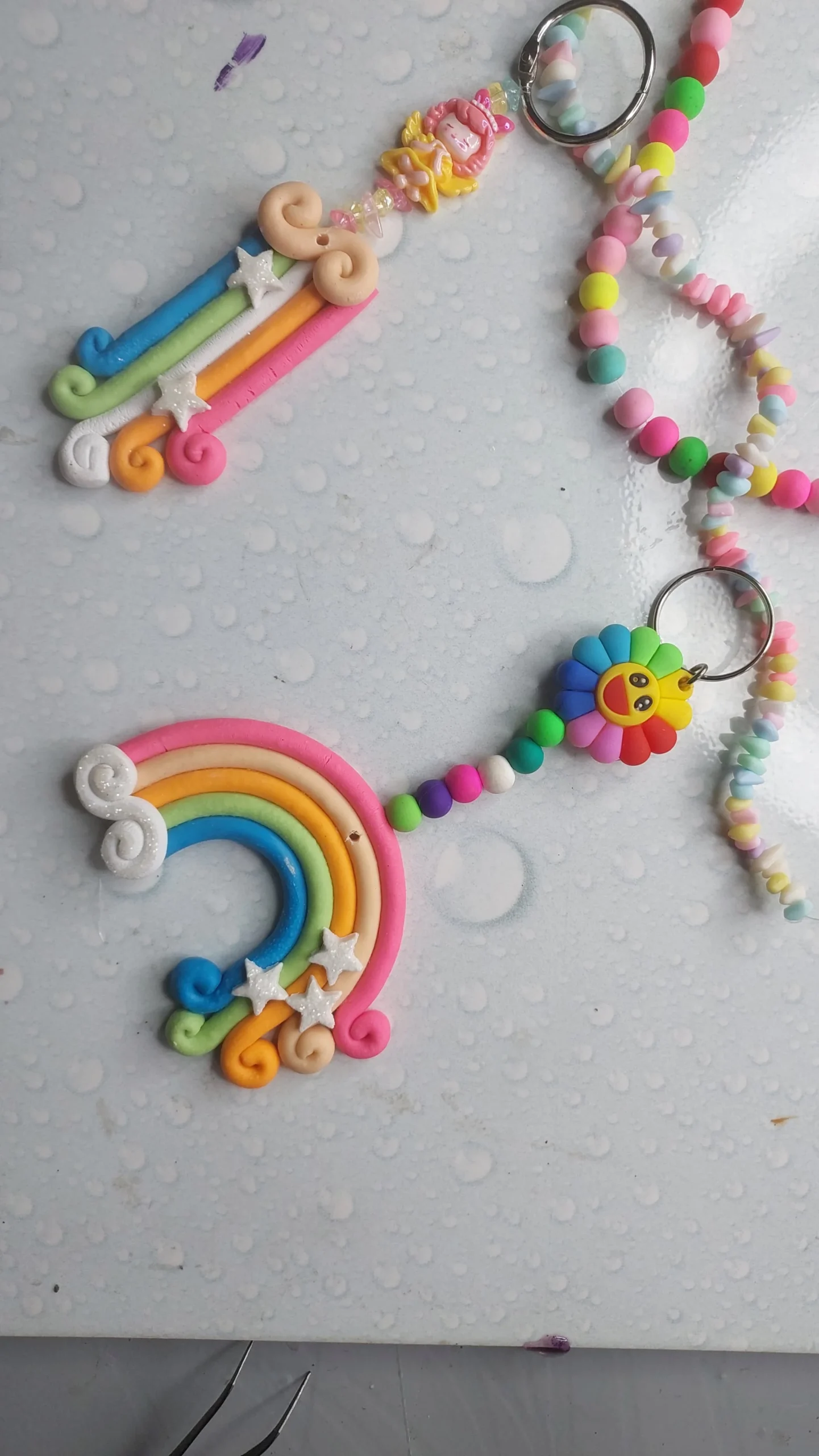 Colorful clay keychain with a rainbow arc, star accents, and a small unicorn bead on a pastel beaded strap with a metal ring rail. - Bling On Decor® | Luxury Handmade Home Decor ANJU BALA