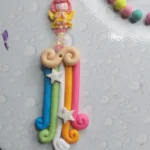 Colorful polymer clay charm keychain with a pink-haired girl figure and pastel bead strands on a silver ring - Bling On Decor® | Luxury Handmade Home Decor ANJU BALA