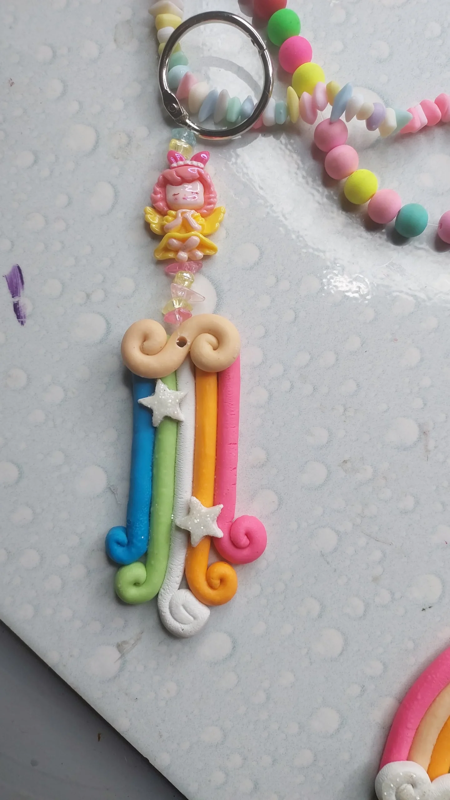 Colorful polymer clay charm keychain with a pink-haired girl figure and pastel bead strands on a silver ring - Bling On Decor® | Luxury Handmade Home Decor ANJU BALA