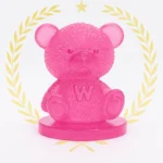 Translucent pink teddy bear figurine on a pink base, with a gold laurel wreath and star above. - Bling On Decor® | Luxury Handmade Home Decor ANJU BALA