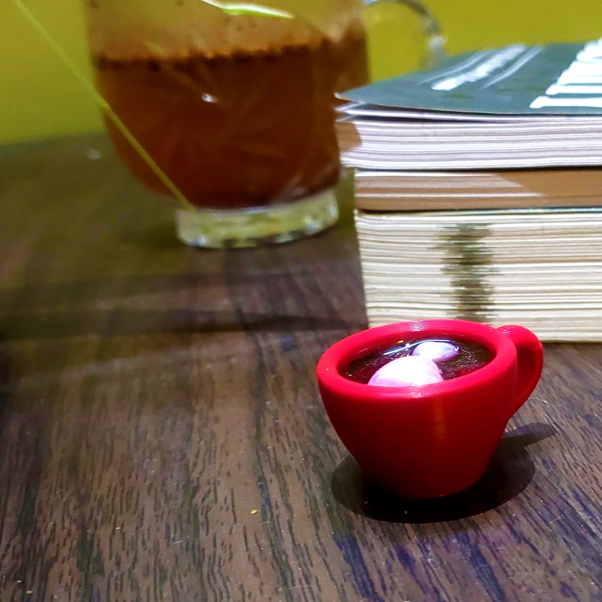 Resin-Love-Cup-table-Top-Desktop-Item-1.webp - Bling On Decor® | Luxury Handmade Home Decor Close-up of a jar of jam beside a stack of papers/notebooks on a wooden surface, with a red cup in the foreground. - Bling On Decor® | Luxury Handmade Home Decor ANJU BALA