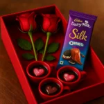 Resin-Love-Cup-table-Top-Desktop-Item-2-table-top-cadbury-silk-oreo-and-red-valentine-rose-webp-2.webp - Bling On Decor® | Luxury Handmade Home Decor Valentine-themed gift: red roses, a Dairy Milk Silk Oreo chocolate bar, and three cups of black coffee with pink heart toppers in a red gift box. - Bling On Decor® | Luxury Handmade Home Decor ANJU BALA