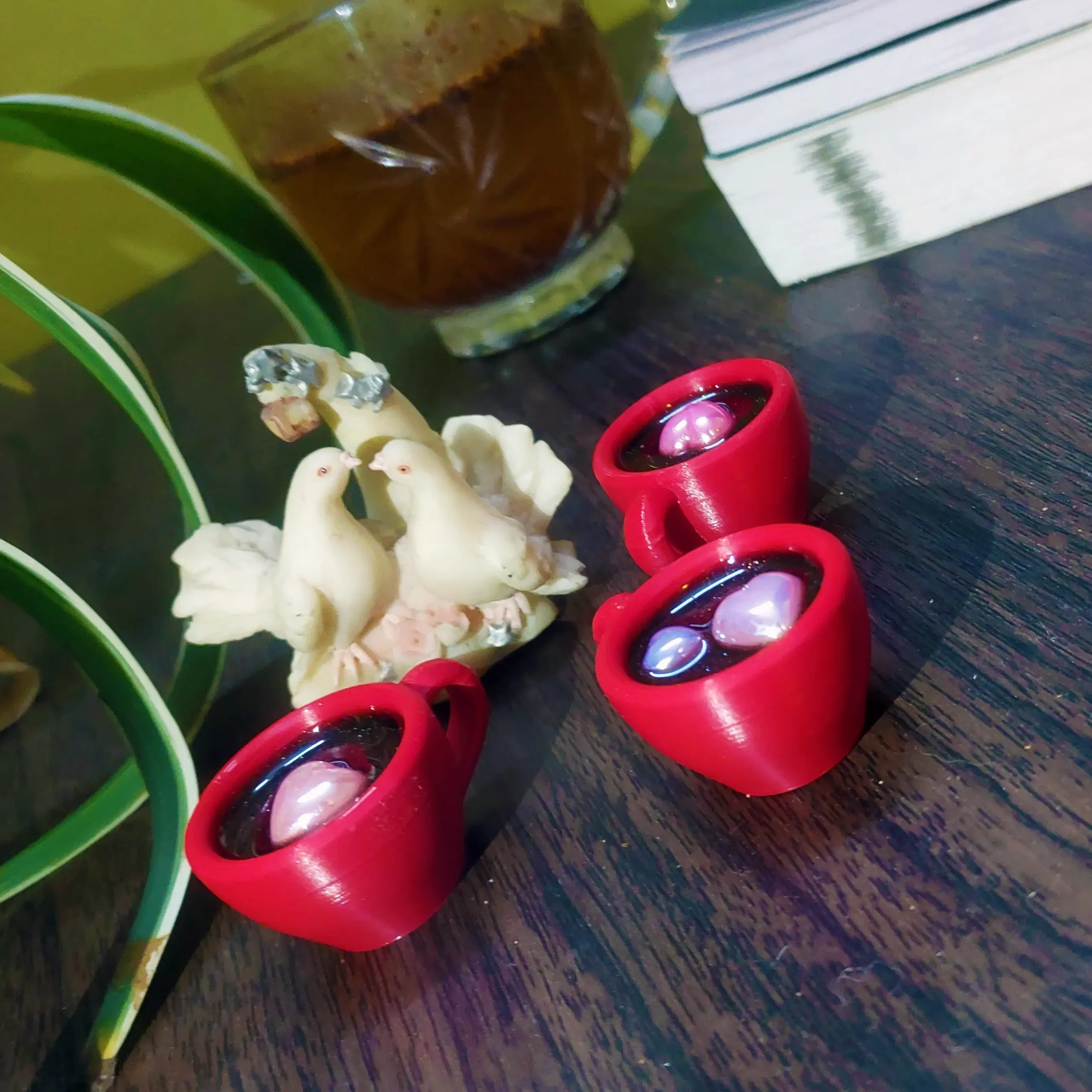 Resin-Love-Cup-table-Top-Desktop-Item-3-scaled-1.webp - Bling On Decor® | Luxury Handmade Home Decor Close-up of red beaded bracelets with purple stones on a dark wooden surface, beside white shell shapes and a green plant leaf - Bling On Decor® | Luxury Handmade Home Decor ANJU BALA