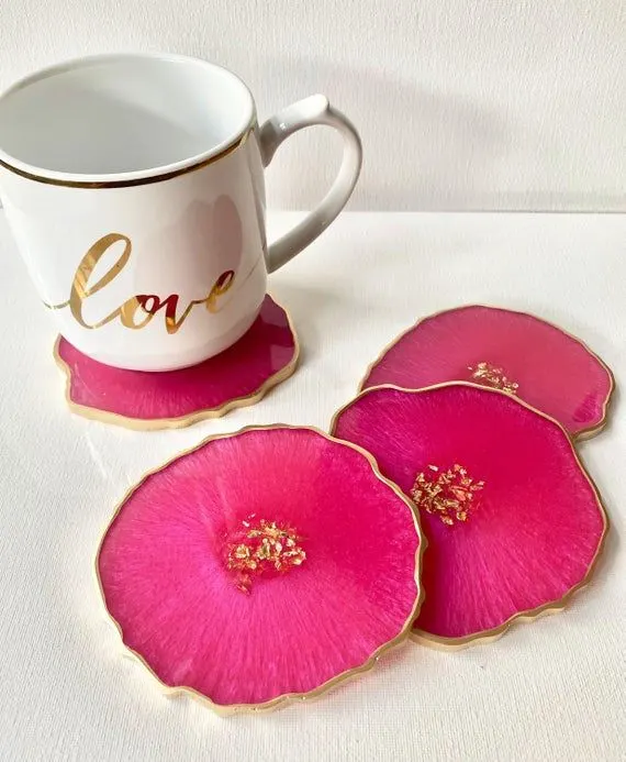 White ceramic mug with a gold rim and the word 'love' in gold, resting on pink, flower-shaped coasters with gold edges. - Bling On Decor® | Luxury Handmade Home Decor ANJU BALA