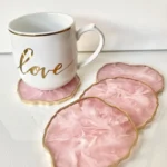 White mug with gold rim and gold 'love' script sits on pink marbled coasters with gold edges - Bling On Decor® | Luxury Handmade Home Decor ANJU BALA