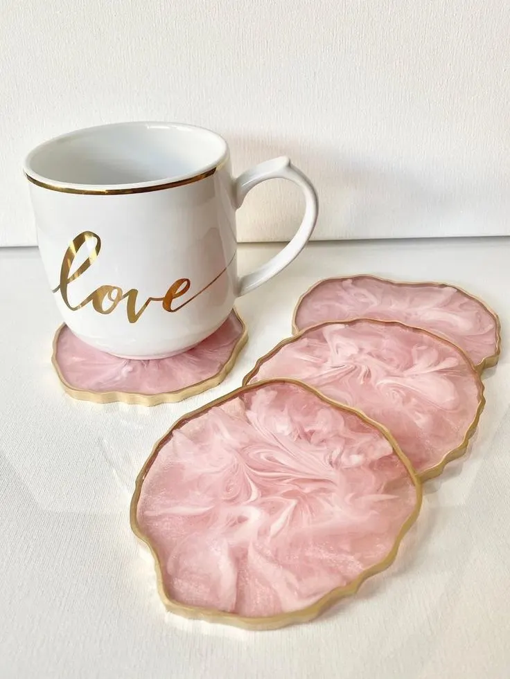 White mug with gold rim and gold 'love' script sits on pink marbled coasters with gold edges - Bling On Decor® | Luxury Handmade Home Decor ANJU BALA