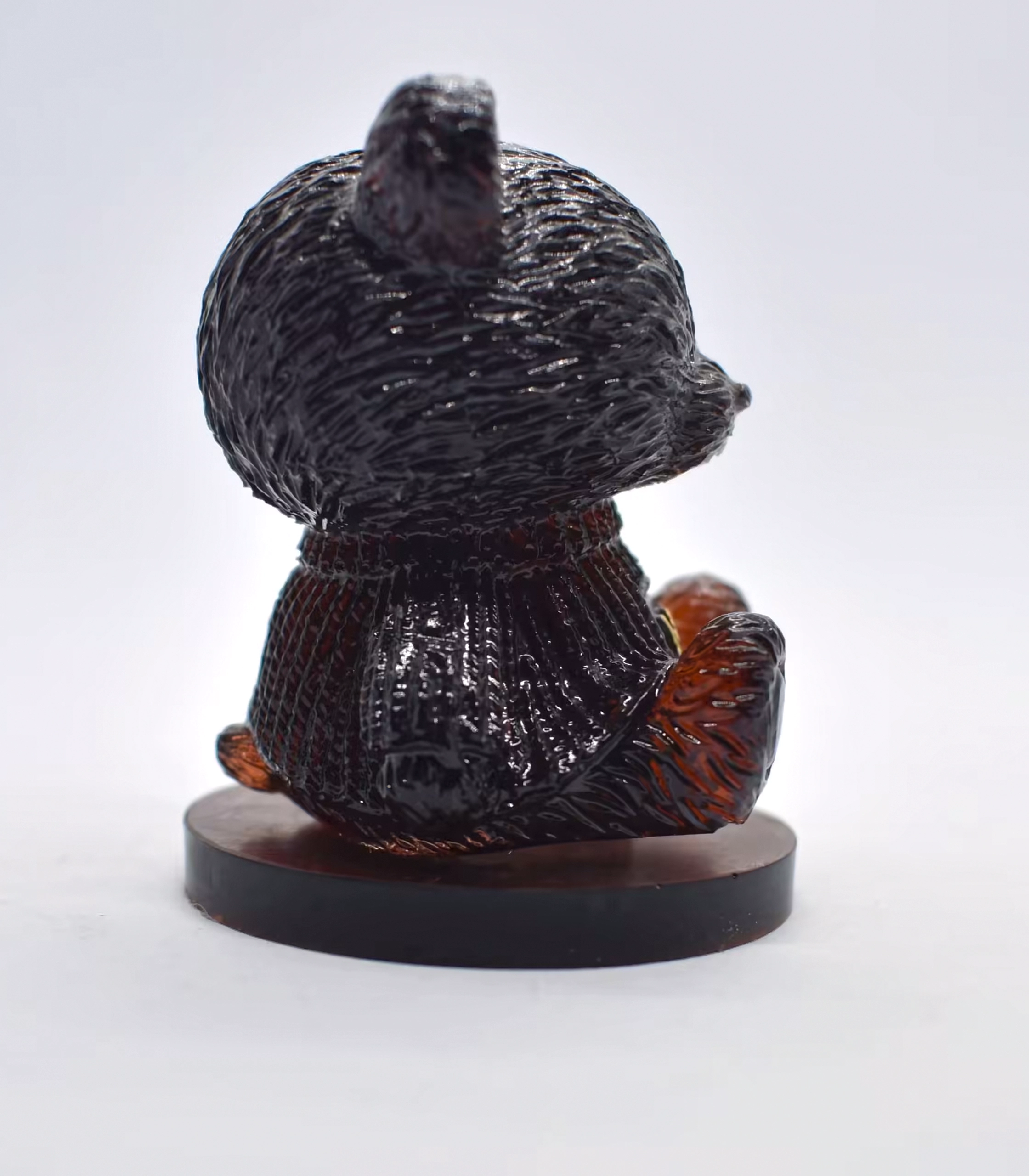 Glossy black rooster statue photographed from below on a round pedestal backdrop lightened behind it. - Bling On Decor® | Luxury Handmade Home Decor ANJU BALA