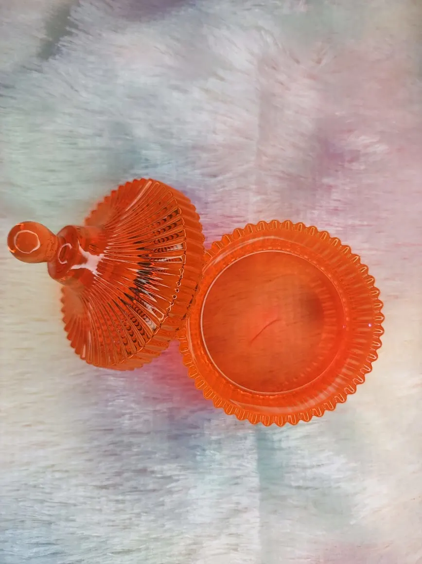 Orange glass candy dish with a fluted lid on a pastel surface. - Bling On Decor® | Luxury Handmade Home Decor ANJU BALA