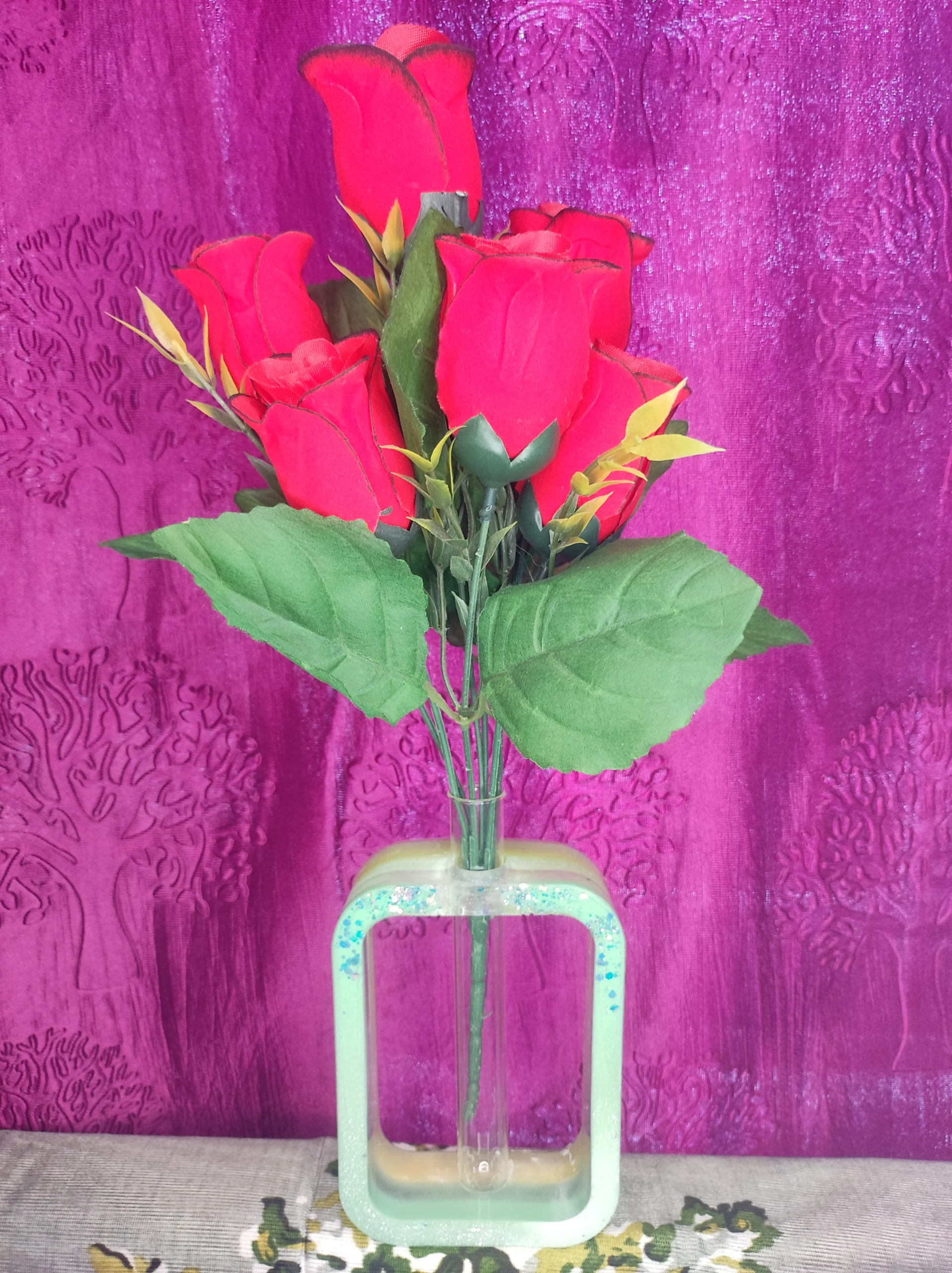 Bouquet of bright red roses in a glass vase against a textured purple backdrop. - Bling On Decor® | Luxury Handmade Home Decor ANJU BALA