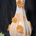 White ceramic vase with orange flower decorations attached along the body. - Bling On Decor® | Luxury Handmade Home Decor ANJU BALA