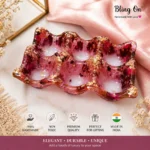 Pink wavy glass tray with gold foil flakes on a pink satin backdrop, a handmade decorative piece for gifting or display. - Bling On Decor® | Luxury Handmade Home Decor ANJU BALA